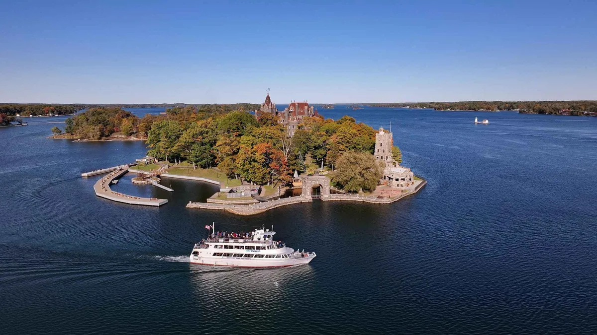 City Cruises sightseeing boat passing pine-covered granite islands on a 1000 Islands cruise from Gananoque, Ontario, Canada